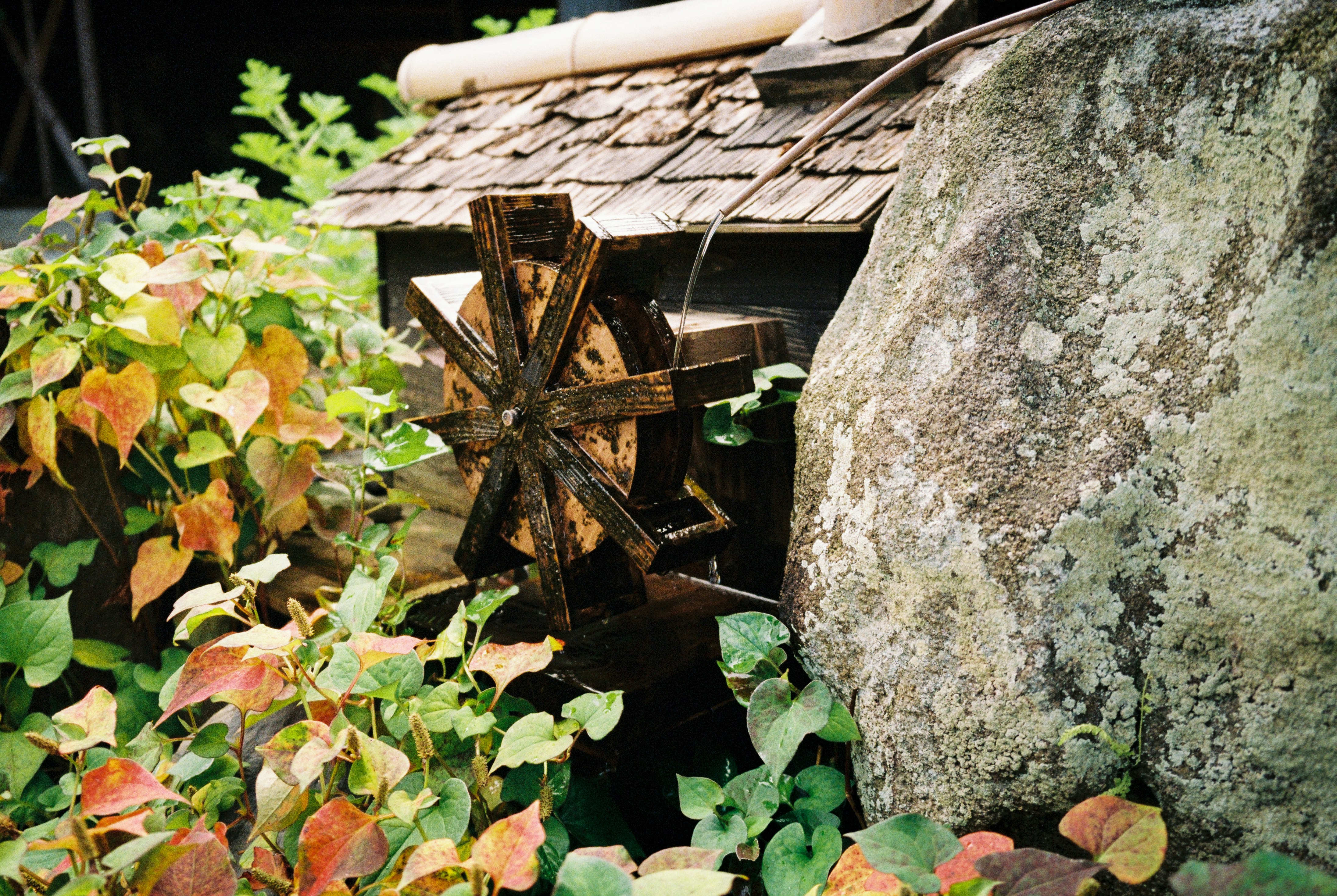 brown wooden cross on gray rock